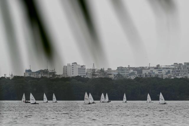 Sailors take part in the International Sailing Championship at Hussain Sagar Lake in Hyderabad on July 15, 2026. (Photo by Noah SEELAM / AFP)