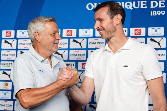 Marseille's new French head coach Bruno Genesio (L) and Marseille's new French football director Gregory Lorenzi (R) pose for pictures during a press conference at the Olympique de Marseille (OM) Robert-Louis-Dreyfus training centre in Marseille, southern France on July 15, 2026 (Photo by CLEMENT MAHOUDEAU / AFP)