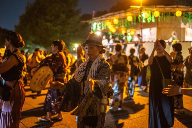 People gather for a folk dance during the Mitama Matsuri, one of the capital's largest summer "obon" festivals, at Yasukuni Shrine in Tokyo on July 15, 2026. (Photo by Philip FONG / AFP)