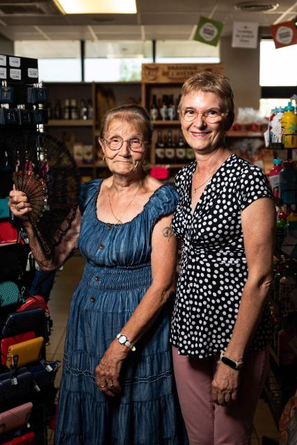 Marie-Agnes and Lilly, two friends, pose during a dance session in a bal musette atmosphere at "La Croix de Mille" service area along the Route Nationale 88 (RN88) in Pampelonne, south-western France on July 14, 2026. "La Croix de Mille" service area welcomes travellers passing along the Route Nationale 88 (RN88) and hosts afternoon dance sessions with a bal musette atmosphere. (Photo by Matthieu RONDEL / AFP)