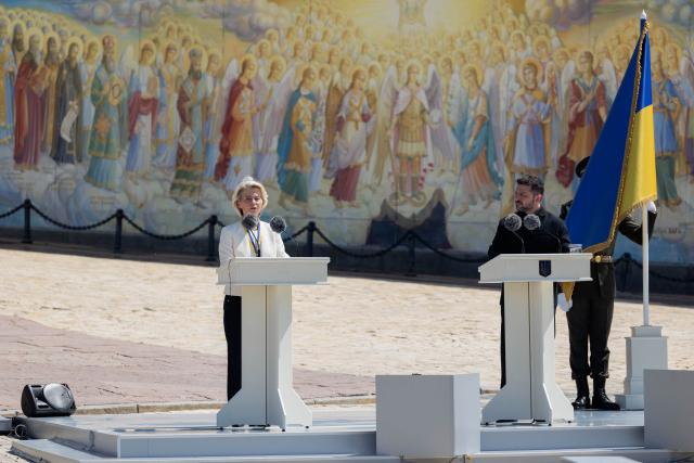 European Commission President Ursula von der Leyen (L), flanked by Ukraine's President Volodymyr Zelensky (R), delivers a speech during a ceremony to mark the Day of Ukrainian Statehood, in Kyiv on July 15, 2026, amid the Russian invasion of Ukraine. EU chief Ursula von der Leyen on July 15 announced a "drone deal" with Ukraine to boost joint production of the key battlefield technology. "This deal will bring together Ukrainian ingenuity and Europe's industrial scale," von der Leyen said in Kyiv, after receiving an award from President Volodymyr Zelensky (Photo by Tetiana DZHAFAROVA / AFP)