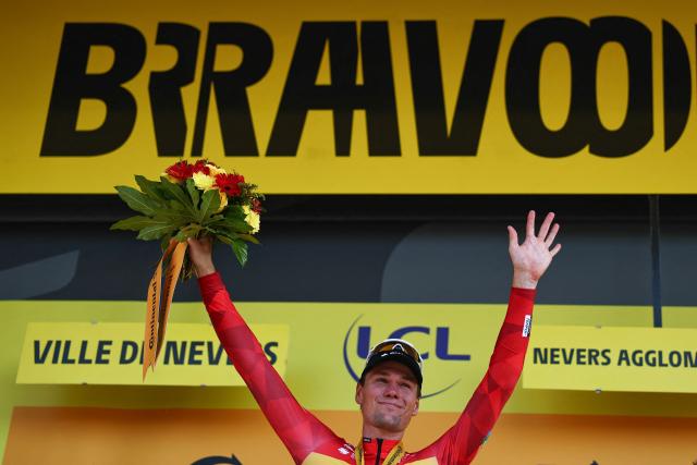 Uno-X Mobility team's Norwegian rider Soren Waerenskjold celebrates on the podium after winning the 11th stage of the 113th edition of the Tour de France cycling race, 161,3 km between Vichy and Nevers in central France, on July 15, 2026. (Photo by Anne-Christine POUJOULAT / AFP)