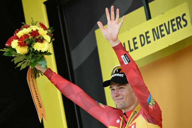 Uno-X Mobility team's Norwegian rider Soren Waerenskjold celebrates on the podium after winning the 11th stage of the 113th edition of the Tour de France cycling race, 161,3 km between Vichy and Nevers in central France, on July 15, 2026. (Photo by Loic VENANCE / AFP)
