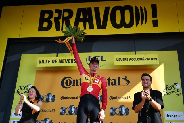 Uno-X Mobility team's Norwegian rider Soren Waerenskjold celebrates on the podium after winning the 11th stage of the 113th edition of the Tour de France cycling race, 161,3 km between Vichy and Nevers in central France, on July 15, 2026. (Photo by Anne-Christine POUJOULAT / AFP)