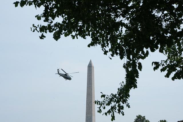Marine One, with US President Donald Trump onboard, flies past the Washington Monument upon departure from the Ellipse near the White House in Washington, DC, on July 15, 2026. President Trump is travelling to Carlisle, Pennsylania to attend the Pennsylvania Defense and Innovation Summit (Photo by Haiyun Jiang / POOL / AFP)