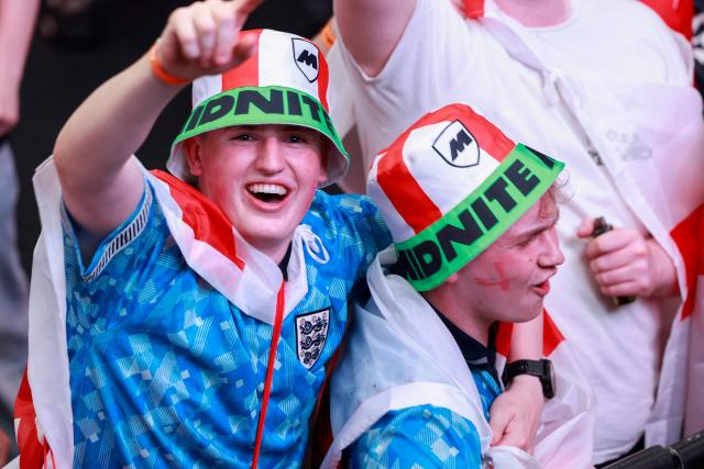 England supporters cheer before the start of a live broadcast of the 2026 World Cup semifinal football match between England and Argentina, at Boxpark Wembley in London on July 15, 2026. (Photo by Brook Mitchell / AFP)
