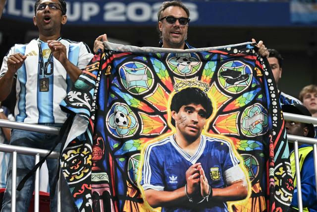 An Argentina supporter holds a flag of former Argentina football player Diego Maradona in the stands ahead of the 2026 World Cup football tournament semi-final match between England and Argentina at the Atlanta Stadium in Atlanta on July 15, 2026.  (Photo by Paul ELLIS / AFP)