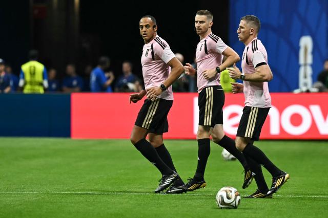 US referee Ismail Elfath (L) walks on the pitch ahead the 2026 World Cup football tournament semi-final match between England and Argentina at the Atlanta Stadium in Atlanta on July 15, 2026.  (Photo by Paul ELLIS / AFP)
