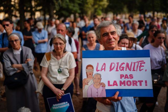 Protesters attend a rally against euthanasia and assisted dying near the French National Assembly in Paris on July 15, 2026. French lawmakers on July 15, 2026, adopted a bill to establish a right to assisted dying for some adults suffering from an incurable condition. (Photo by Dimitar DILKOFF / AFP)