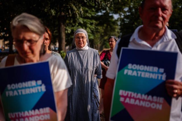 Protesters attend a rally against euthanasia and assisted dying near the French National Assembly in Paris on July 15, 2026. French lawmakers on July 15, 2026, adopted a bill to establish a right to assisted dying for some adults suffering from an incurable condition. (Photo by Dimitar DILKOFF / AFP)