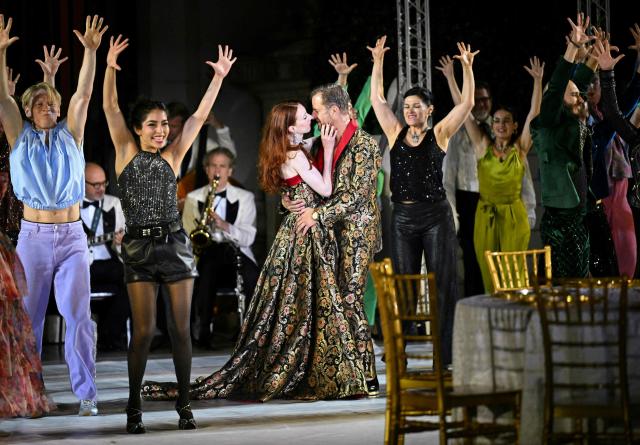 Austrian actor Philipp Hochmair (Jedermann) and Roxane Duran perform during a rehearsal for the play "Jedermann" by Hugo von Hofmannsthal at Salzburg's Cathedral Square (Domplatz) in Salzburg, Austria, on July 15, 2026, as preparations are underway for the 2026 edition of the Salzburger Festspiele, the city's festival for opera, drama and concerts. The Salzburg Festival 2026 edition will take place July 17 to August 30, 2026. (Photo by BARBARA GINDL / APA / AFP) / Austria OUT
