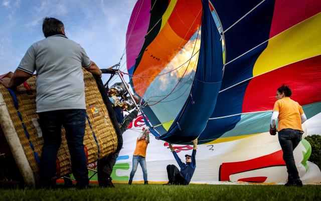 Participants inflate hot air balloons during the 40th edition of the Frisian Balloon Festival in Joure, northern Netherlands on July 15, 2026. (Photo by Koen van Weel / ANP / AFP) / Netherlands OUT