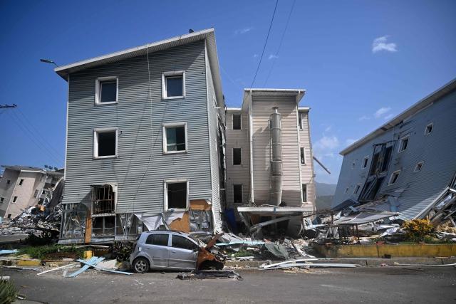 Buildings at the Urbanismo Comunidad Socialista Residencias Hugo Chavez are seen damaged in Catia La Mar, La Guaira state, Venezuela, on July 15, 2026, following the June 24 twin earthquakes. The death toll from the earthquakes that struck Venezuela almost three weeks ago has surpassed 4,700, while almost 17,000 people have been injured, an official report released on July 14, 2026 stated. (Photo by Juan BARRETO / AFP)
