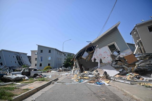 Buildings at the Urbanismo Comunidad Socialista Residencias Hugo Chavez are seen damaged in Catia La Mar, La Guaira state, Venezuela, on July 15, 2026, following the June 24 twin earthquakes. The death toll from the earthquakes that struck Venezuela almost three weeks ago has surpassed 4,700, while almost 17,000 people have been injured, an official report released on July 14, 2026 stated. (Photo by Juan BARRETO / AFP)