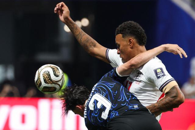 England's midfielder #17 Morgan Rogers (R) and Argentina's defender #03 Nicolas Tagliafico fight for the ball during the 2026 World Cup football tournament semi-final match between England and Argentina at the Atlanta Stadium in Atlanta on July 15, 2026.  (Photo by Odd ANDERSEN / AFP)