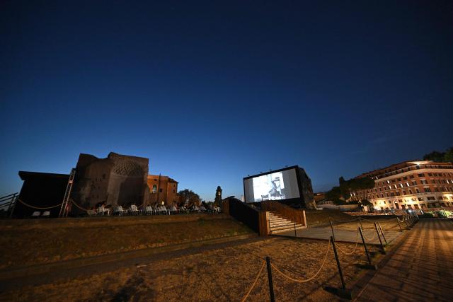 Attendees watch a film during the summer edition of Cinema Festival "QUO VADIS?", at Temple of Venus, the ancient Roman Forum, near the ancient Colosseum, in Rome on July 15, 2026. (Photo by Andreas SOLARO / AFP)
