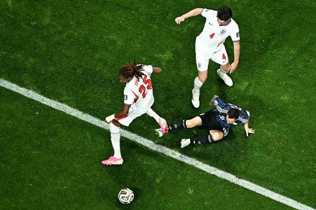 Argentina's forward #10 Lionel Messi falls to the pitch as he fights for the ball with England's defender #25 Djed Spence and England's midfielder #04 Declan Rice during the 2026 World Cup football tournament semi-final match between England and Argentina at the Atlanta Stadium in Atlanta on July 15, 2026.  (Photo by Jewel SAMAD / AFP)