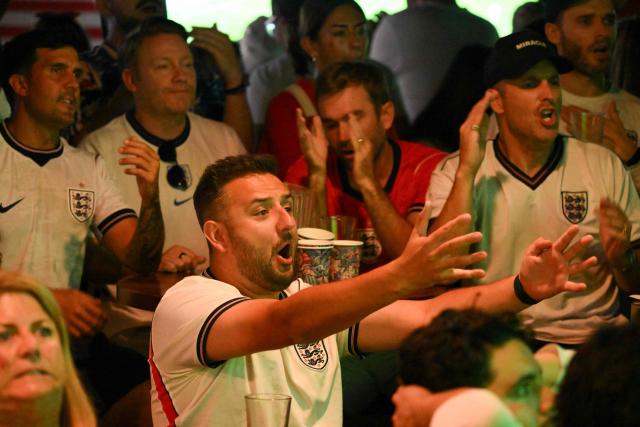 An England fan gestures while watching the 2026 World Cup semi-final match between England and Argentina at the Underground Pub & Grill in Hermosa Beach, California, on July 15, 2026. (Photo by Patrick T. Fallon / AFP)