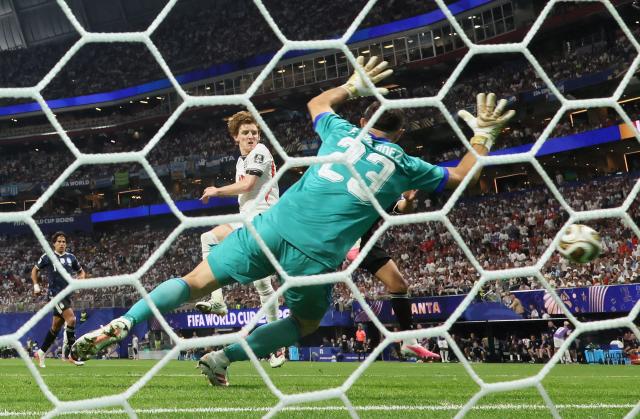 England's forward #18 Anthony Gordon scores his team's first goal past Argentina's goalkeeper #23 Emiliano Martinez during the 2026 World Cup football tournament semi-final match between England and Argentina at the Atlanta Stadium in Atlanta on July 15, 2026.  (Photo by Odd ANDERSEN / AFP)