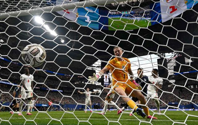 Argentina's forward #22 Lautaro Martinez scores his team's second goal past England's goalkeeper #01 Jordan Pickford during the 2026 World Cup football tournament semi-final match between England and Argentina at the Atlanta Stadium in Atlanta on July 15, 2026.  (Photo by Paul ELLIS / AFP)