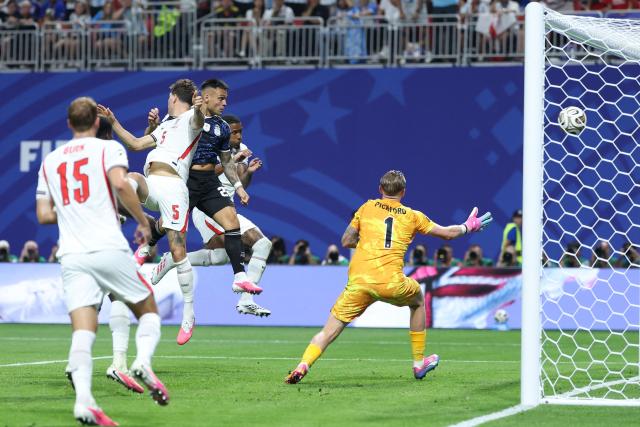 Argentina's forward #22 Lautaro Martinez heads the ball and scores his team's second goal during the 2026 World Cup football tournament semi-final match between England and Argentina at the Atlanta Stadium in Atlanta on July 15, 2026.  (Photo by Thomas COEX / AFP)