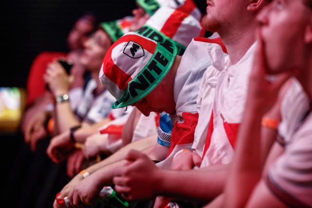 England supporters react near the end of play as people watch a live broadcast of the 2026 World Cup semifinal football match between England and Argentina, at Boxpark Wembley in London on July 15, 2026. (Photo by Brook Mitchell / AFP)