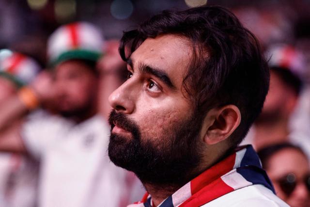An England supporter reacts at the end of play as people watch a live broadcast of the 2026 World Cup semifinal football match between England and Argentina, at Boxpark Wembley in London on July 15, 2026. (Photo by Brook Mitchell / AFP)