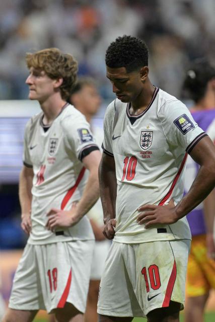 England's midfielder #10 Jude Bellingham (R) and England's forward #18 Anthony Gordon (L) react to their team's defeat at the end of the 2026 World Cup football tournament semi-final match between England and Argentina at the Atlanta Stadium in Atlanta on July 15, 2026.  (Photo by JUAN MABROMATA / AFP)