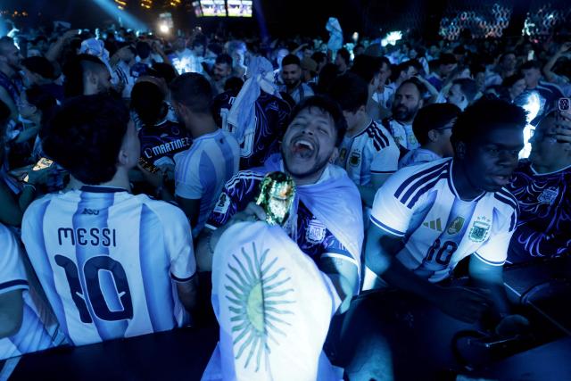 Argentina's supporters celebrate victory at the end of the 2026 World Cup semi-final match between England and Argentina in Madrid, on July 15, 2026. (Photo by Oscar DEL POZO / AFP)