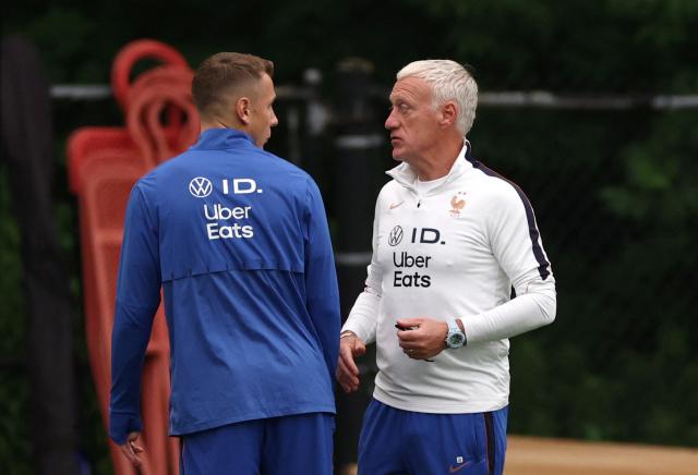 France's head coach Didier Deschamps talks to his defender #03 Lucas Digne during a training session at Bentley University in Waltham, near Boston on July 15, 2026. (Photo by FRANCK FIFE / AFP)