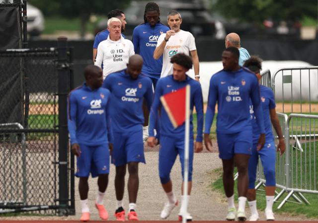 France's head coach Didier Deschamps (L) and his fitness coach Cyril Moine arrive for a training session at Bentley University in Waltham, near Boston on July 15, 2026. (Photo by FRANCK FIFE / AFP)