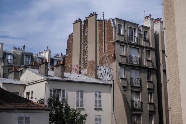 This photograph shows a view of residential buildings with closed window shutters amid a heatwave in Paris on July 15, 2026. The Paris region, and large parts of the rest of France, is currently experiencing the third heatwave since May 2026, increasing the risk of fires. The three heatwaves have seen temperature records broken in several countries across Europe and have caused thousands of excess deaths, according to estimates in Belgium, Britain, France and Spain. (Photo by Martin LELIEVRE / AFP)