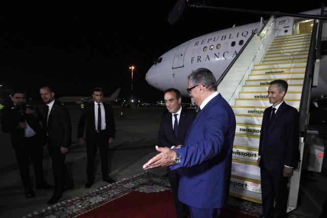 French Prime Minister Sébastien Lecornu (C) is greeted by Moroccan Prime Minister Aziz Akhannouch (R) upon his arrival at Rabat-Salé Airport in Rabat on July 15, 2026. (Photo by Abdel Majid BZIOUAT / AFP)