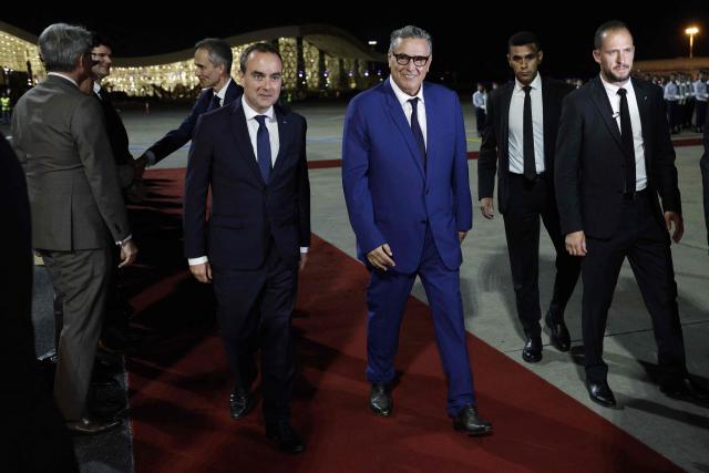 Morocco's Prime Minister Aziz Akhannouch (R) walks with France's Prime Minister Sébastien Lecornu upon his arrival at Rabat-Salé Airport in Rabat on July 15, 2026. (Photo by Abdel Majid BZIOUAT / AFP)