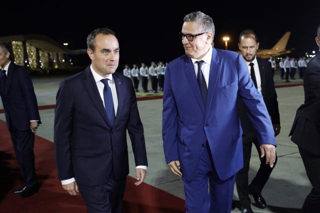 Morocco's Prime Minister Aziz Akhannouch (R) walks with France's Prime Minister Sébastien Lecornu upon his arrival at Rabat-Salé Airport in Rabat on July 15, 2026. (Photo by Abdel Majid BZIOUAT / AFP)
