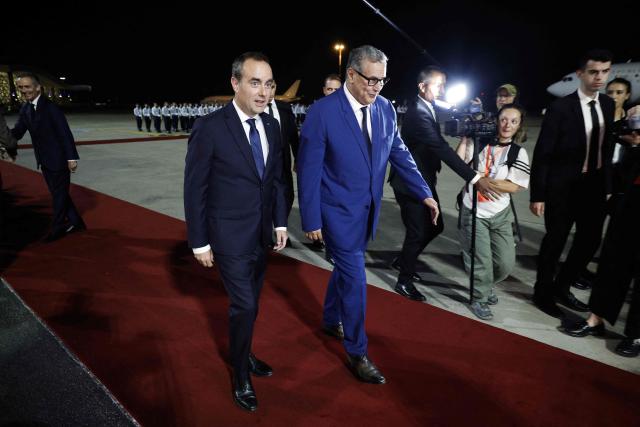 Morocco's Prime Minister Aziz Akhannouch (R) walks with France's Prime Minister Sébastien Lecornu upon his arrival at Rabat-Salé Airport in Rabat on July 15, 2026. (Photo by Abdel Majid BZIOUAT / AFP)