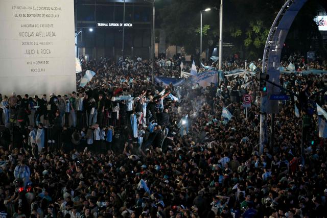 Fans celebrate Argentina's victory over England in the 2026 FIFA World Cup semi-final football match at the Obelisk in Buenos Aires on July 15, 2026. (Photo by Luis ROBAYO / AFP)