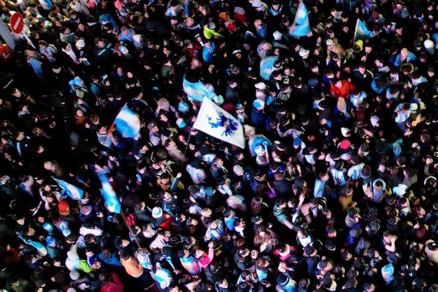 In this aerial view a flag with the map of the Falkland Islands (Islas Malvinas) (C) is seen as fans celebrate Argentina's victory over England in the 2026 FIFA World Cup semi-final football match in Ushuaia, southern Argentina, on July 15, 2026. (Photo by Cristian Urrutia / AFP)