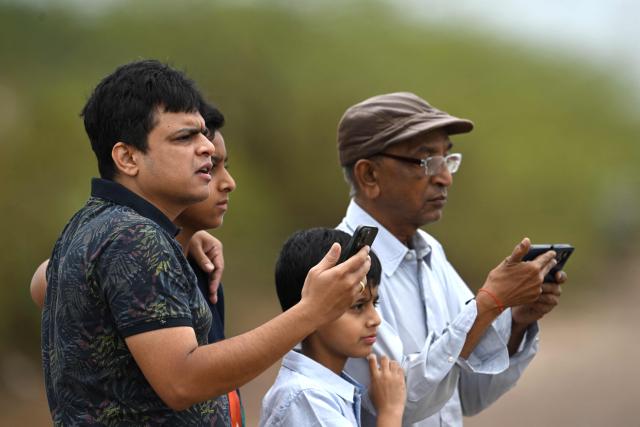 People gathered at Pulicat Lake to witness the launch of India's Skyroot Aerospace orbital rocket Vikram-1 from the Satish Dhawan Space Centre in Andhra Pradesh's Sriharikota on July 18, 2026. (Photo by R.Satish BABU / AFP)
