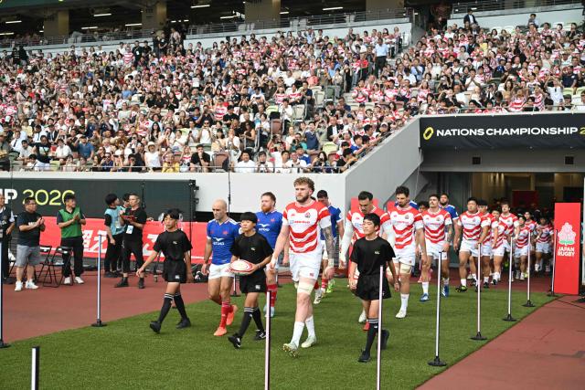 The French and Japanese teams walk onto the field for their rugby union Nations Championship match at the National Stadium in Tokyo on July 18, 2026. (Photo by ANDREW CABALLERO-REYNOLDS / AFP)