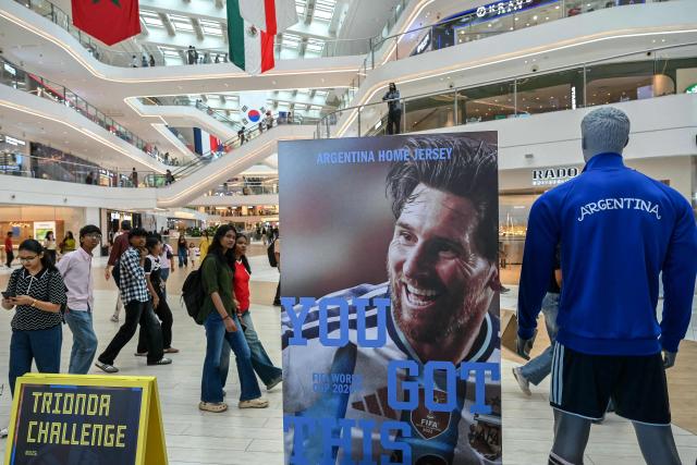 Shoppers walk past an installation featuring Argentinian footballer Lionel Messi at the Sky City mall in Mumbai on July 18, 2026 on the eve of the 2026 FIFA World Cup football tournament final match between Spain and Argentina. (Photo by Indranil MUKHERJEE / AFP)