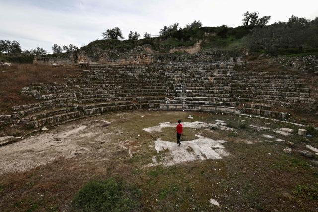 (FILES) A boy walks in the amphitheatre at the archaeological site of Sebastia, west of the occupied West Bank city of Nablus on February 12, 2026. The United Nations looks set to list a Biblical site, Lebanese castles, an antelope migration path and the world's deepest lake as world treasures under threat, including from war or climate change. The 196 members states of the United Nations Educational, Scientific and Cultural Organisation (UNESCO) are to cast votes from Friday next week on new additions to its World Heritage and World Heritage in Danger lists when they meet in Busan, South Korea. (Photo by Zain JAAFAR / AFP)