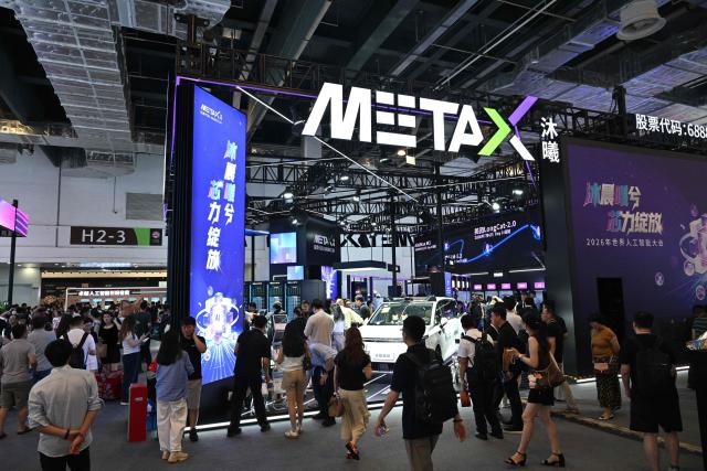People visit the Metax booth during the World Artificial Intelligence Conference (WAIC) in Shanghai on July 18, 2026. (Photo by Hector RETAMAL / AFP)