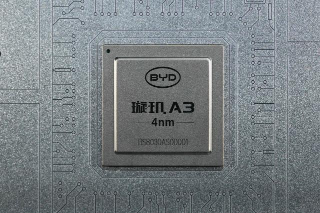 A Xuanji A3 chip is pictured at the BYD booth during the World Artificial Intelligence Conference (WAIC) in Shanghai on July 18, 2026. (Photo by Hector RETAMAL / AFP)