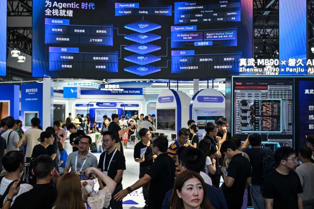 People visit the Alibaba booth during the World Artificial Intelligence Conference (WAIC) in Shanghai on July 18, 2026. (Photo by Hector RETAMAL / AFP)