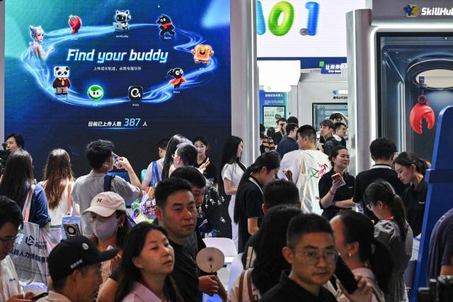People visit the Tencent booth during the World Artificial Intelligence Conference (WAIC) in Shanghai on July 18, 2026. (Photo by Hector RETAMAL / AFP)