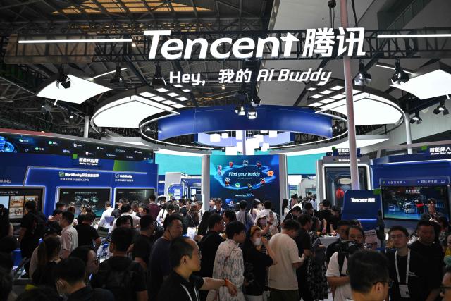 People visit the Tencent booth during the World Artificial Intelligence Conference (WAIC) in Shanghai on July 18, 2026. (Photo by Hector RETAMAL / AFP)