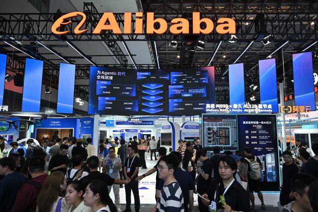 People visit the Alibaba booth during the World Artificial Intelligence Conference (WAIC) in Shanghai on July 18, 2026. (Photo by Hector RETAMAL / AFP)