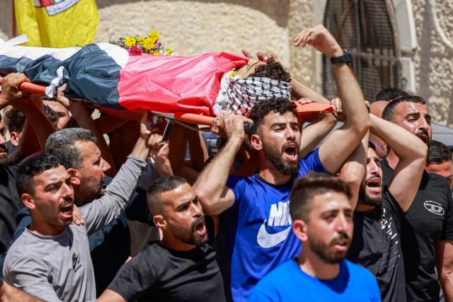 EDITORS NOTE: Graphic content / Mourners carry the body of 17-year-old Fadi al-Naasan during his funeral in the village of Al-Mughayyir, east of Ramallah in the Israeli-occupied West Bank, on July 18, 2026, after he died from wounds sustained about a week ago during clashes with Israeli forces. The occupied West Bank has been gripped by almost daily violence involving Israeli troops and settlers since the start of the Gaza war in October 2023. (Photo by Jaafar ASHTIYEH / AFP)