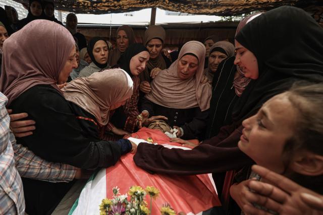 EDITORS NOTE: Graphic content / Relatives mourn over the body of 17-year-old Fadi al-Naasan during his funeral in the village of Al-Mughayyir, east of Ramallah in the Israeli-occupied West Bank, on July 18, 2026, after he died from wounds sustained about a week ago during clashes with Israeli forces. The occupied West Bank has been gripped by almost daily violence involving Israeli troops and settlers since the start of the Gaza war in October 2023. (Photo by JAAFAR ASHTIYEH / AFP)